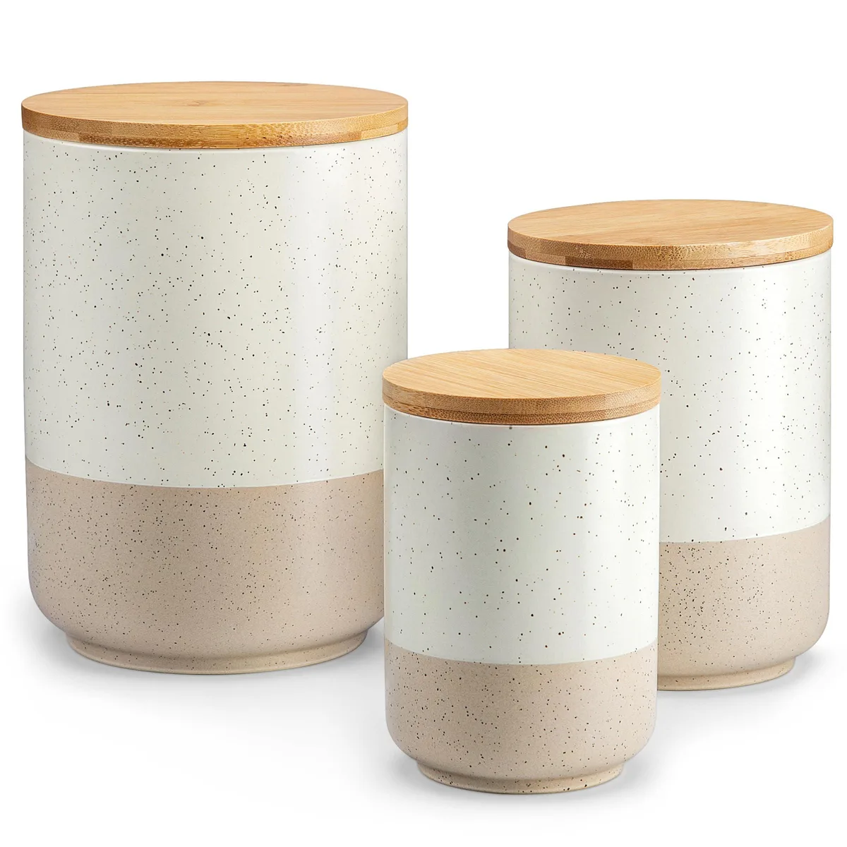 Three white ceramic canisters with wood lids, speckled finish, varying heights