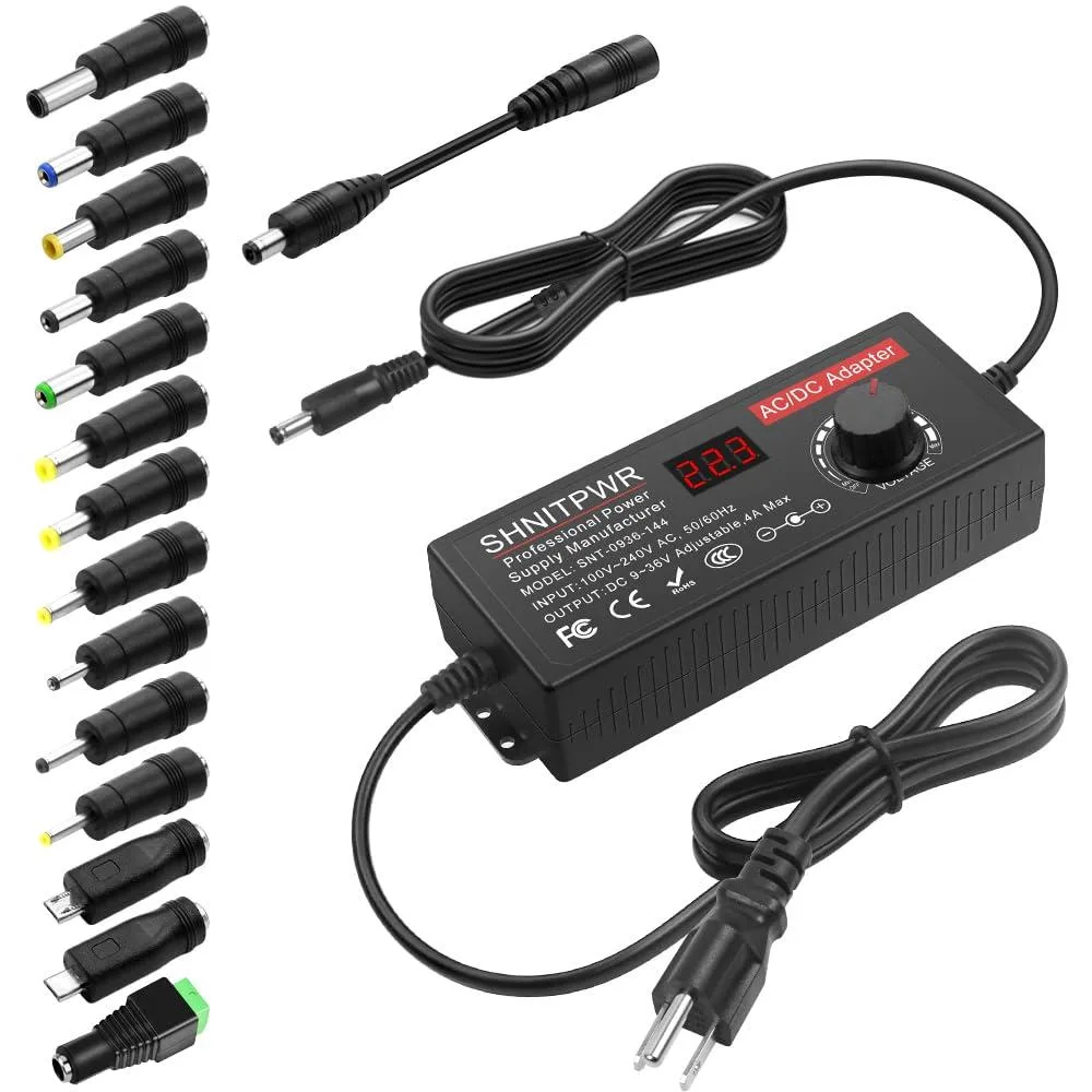 Black rectangular power brick with LCD screen, rotary knob and multiple interchangeable DC tips