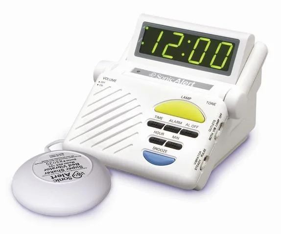 White rectangular alarm clock with vibrating pad on desk