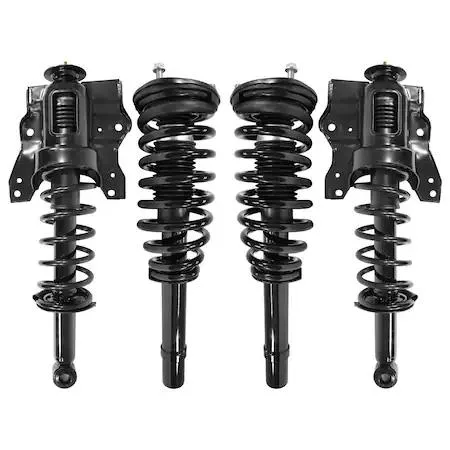 Four silver strut assemblies with black springs on grey surface