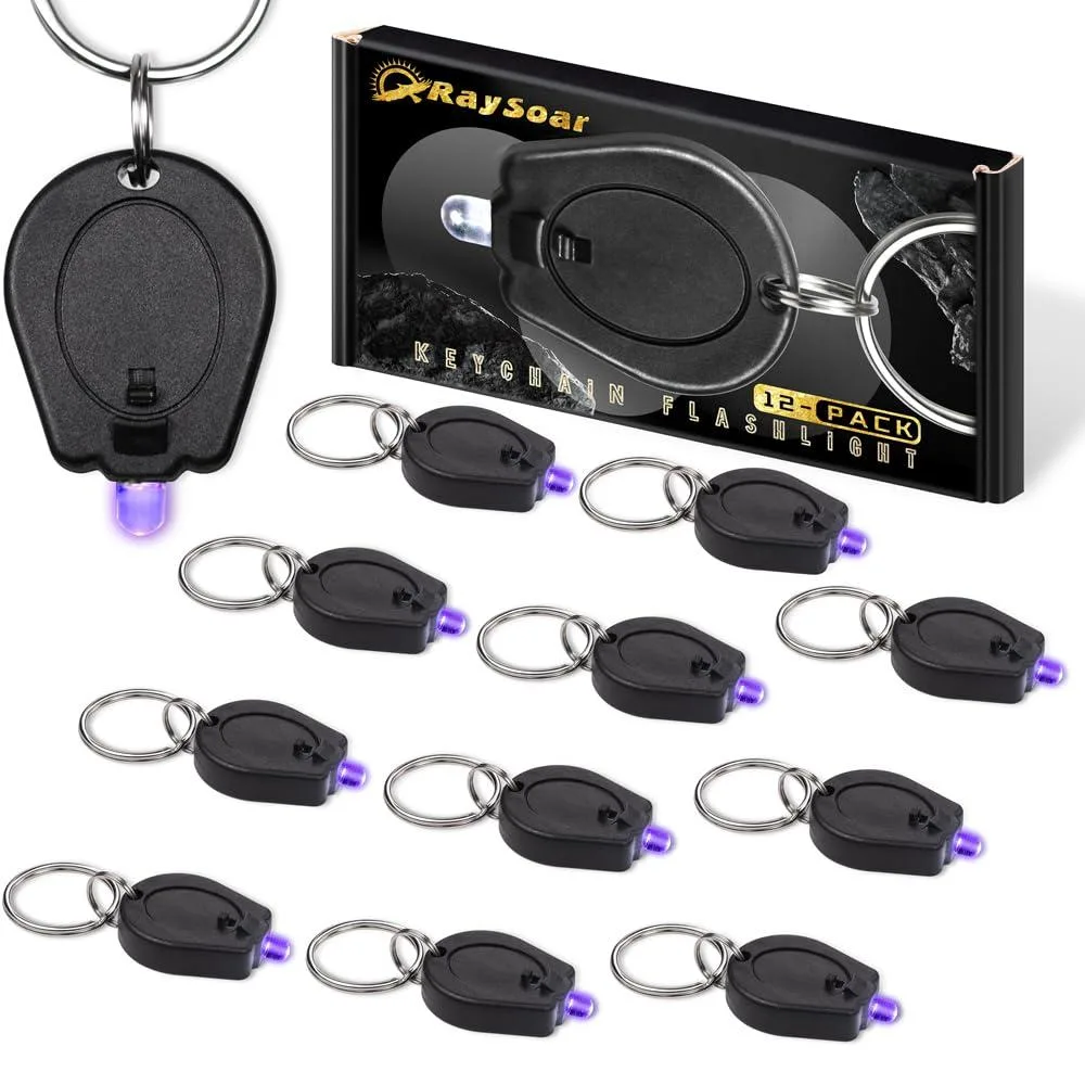 Twelve tiny black keychain UV lights with slide switches and pinch activation