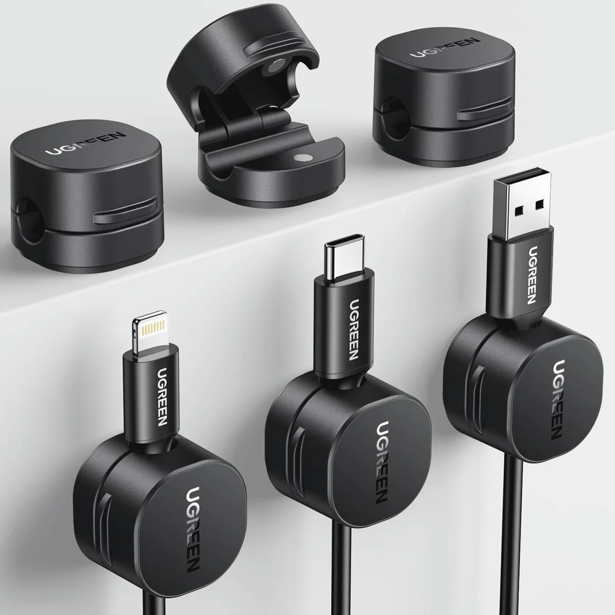 Six small black rectangular magnetic clips with adhesive backing, each about 25.3 by 24 by 18.5 millimetres