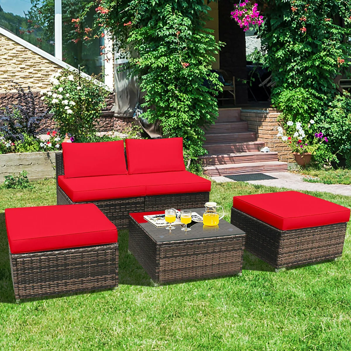 Five-piece red rattan patio sofa set with cushions and glass-top table