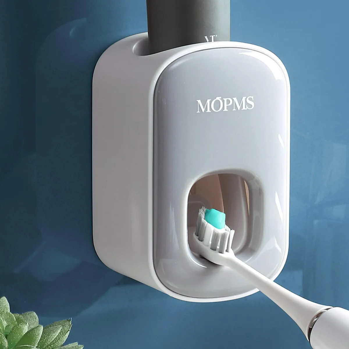 Grey rectangular plastic toothpaste dispenser, wall-mounted, 14.33in wide, 12.83in high, 9.06in deep