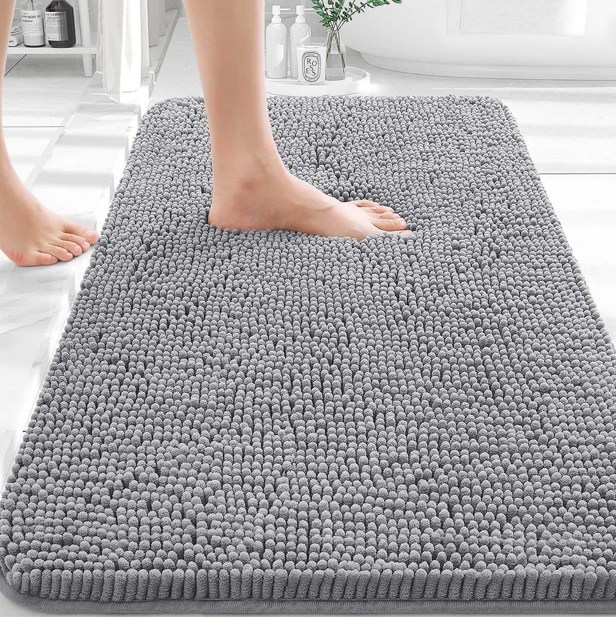 Rectangular grey chenille bath rug, 30 by 20 inches, rubber backing
