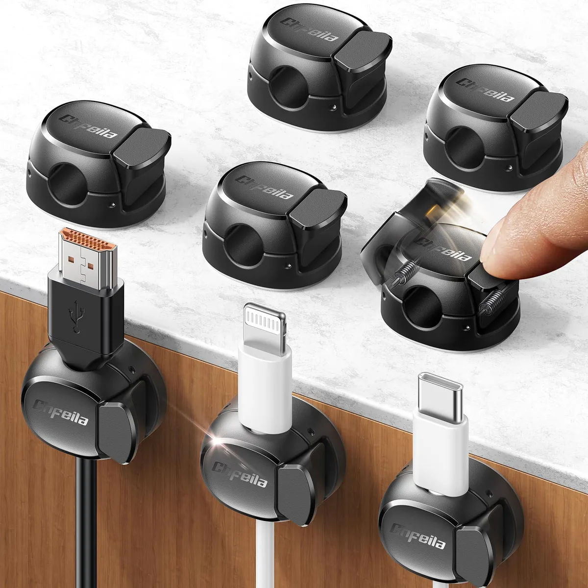 Eight small black plastic cable clips with adhesive backs, each about one inch long and a tenth of an inch high
