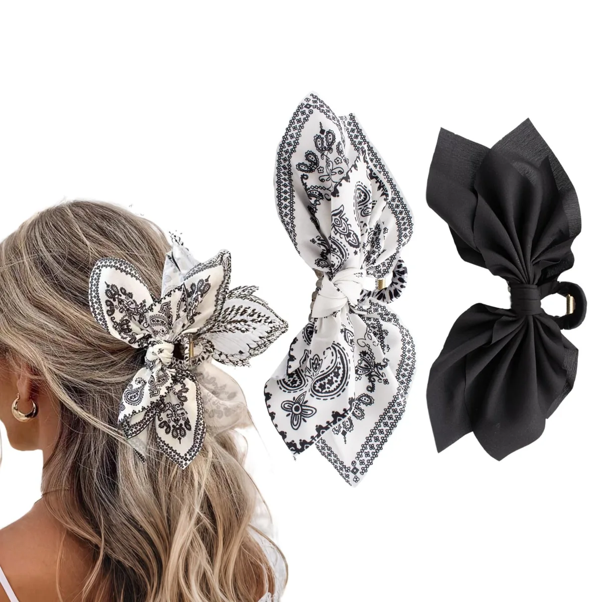 Two black and white paisley bow claw clips on a light background