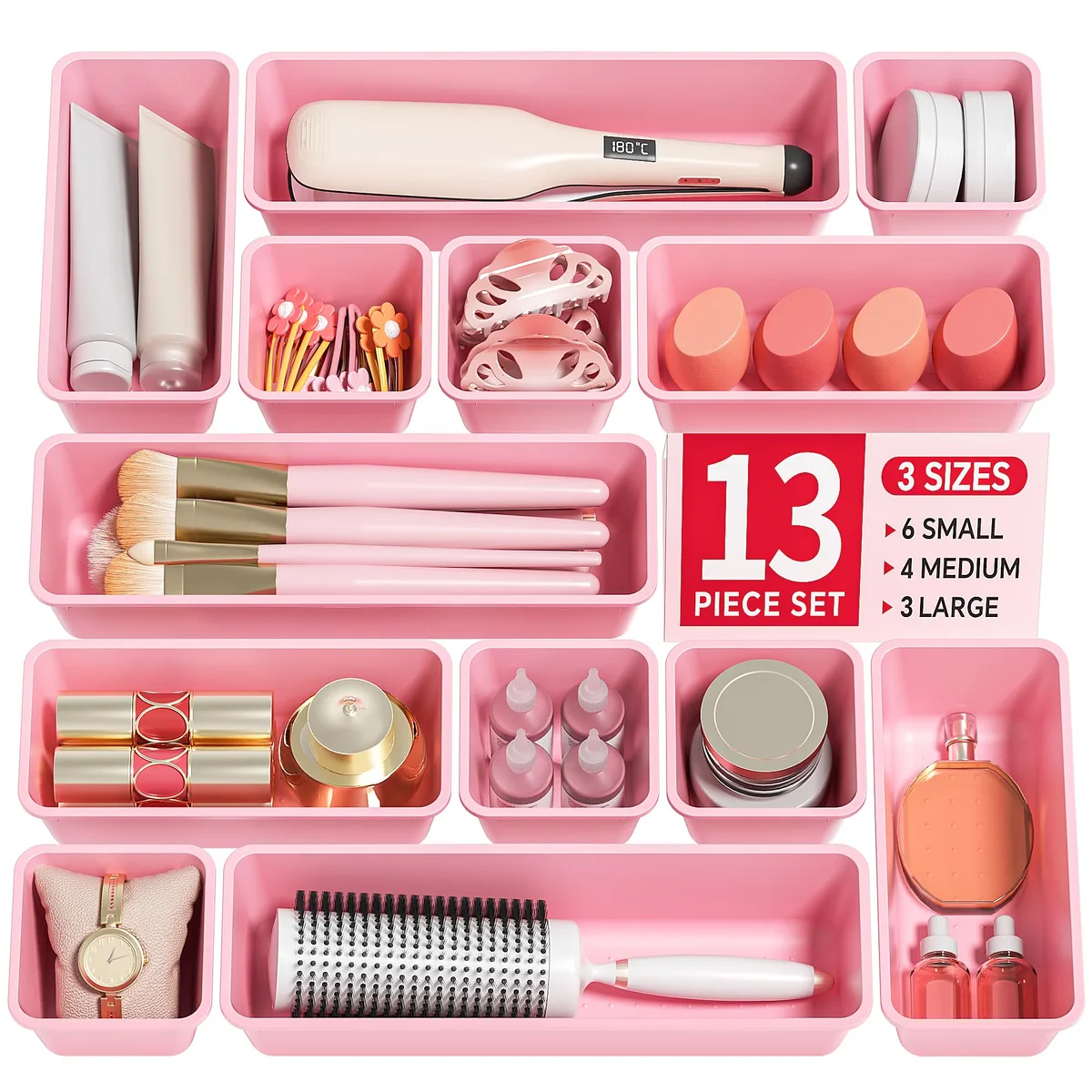 Thirteen pink plastic drawer trays in three sizes stacked together