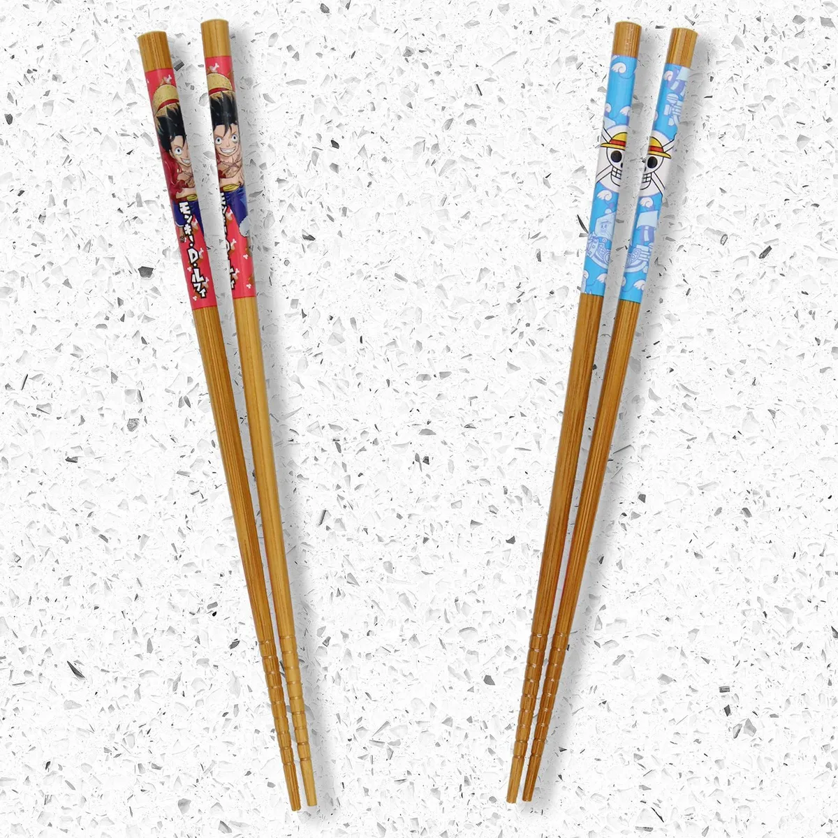 Two pairs of black bamboo chopsticks with printed anime designs, 8.85 inches long