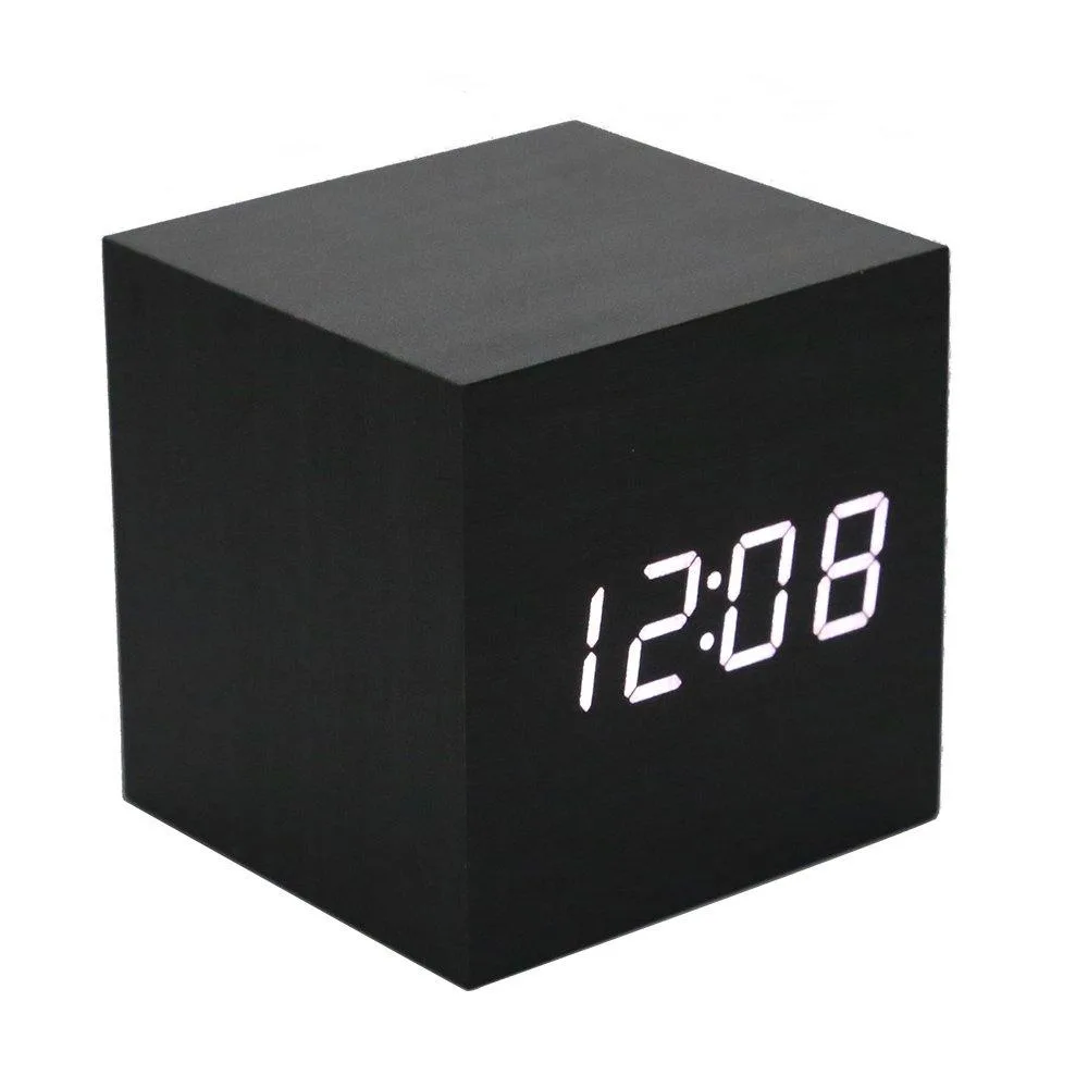Small wooden cube clock with black and white finish, LED display showing time and temperature, USB cable included