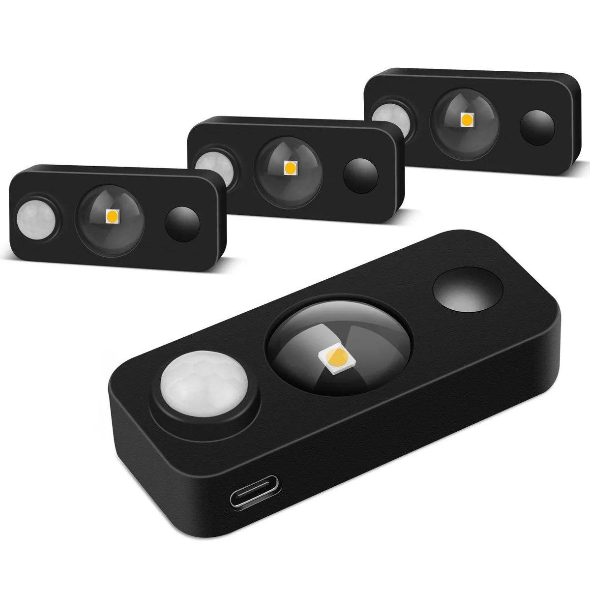 Four white round puck lights with clear prismatic lenses shown together