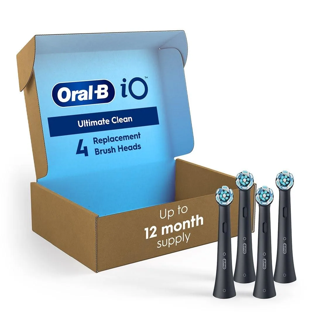 Four black electric toothbrush heads in a rectangular pack