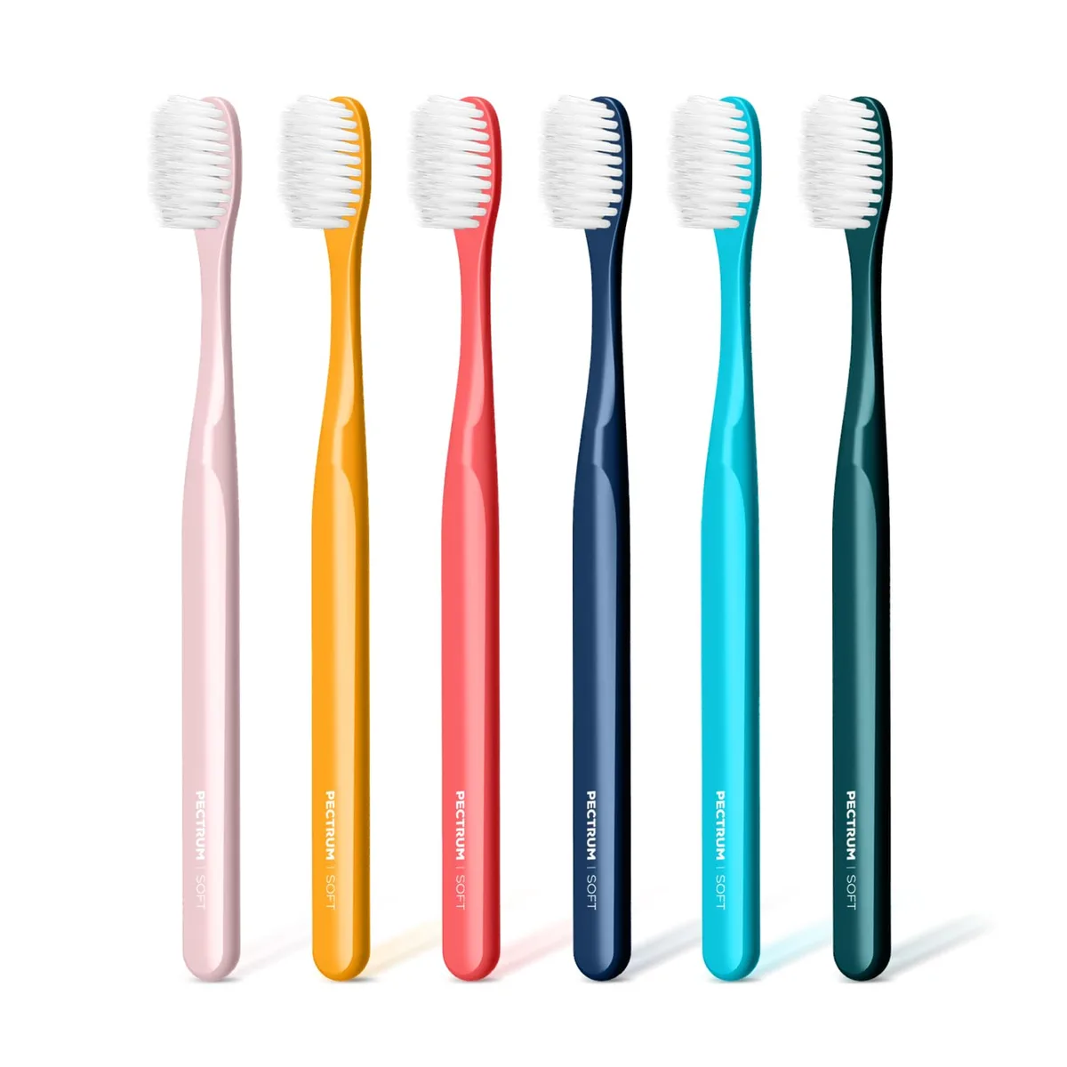 Six white manual toothbrushes with extra soft tapered bristles in a pack