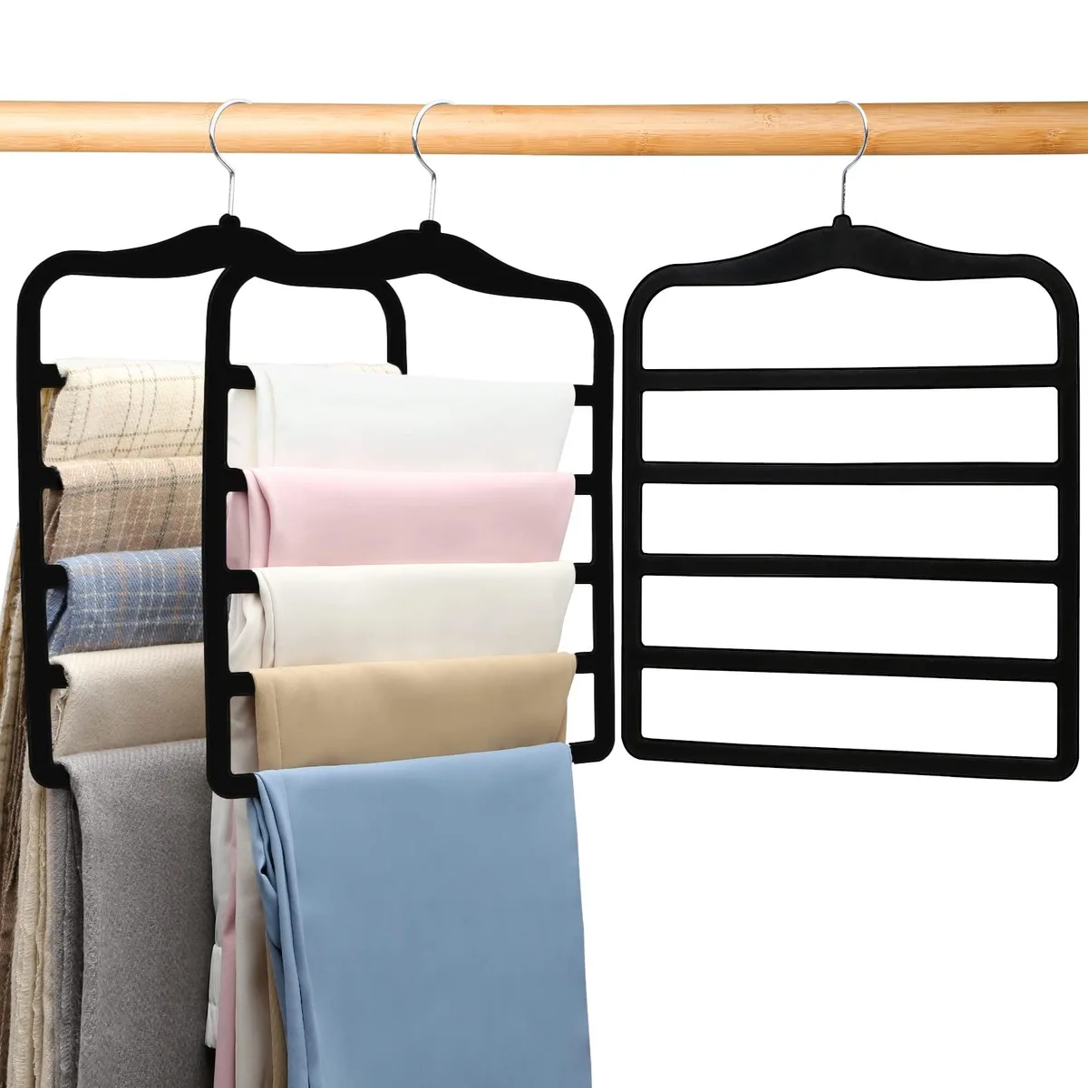 Three black velvet pants hangers with 360-degree swivel hooks, each holding five pairs of trousers