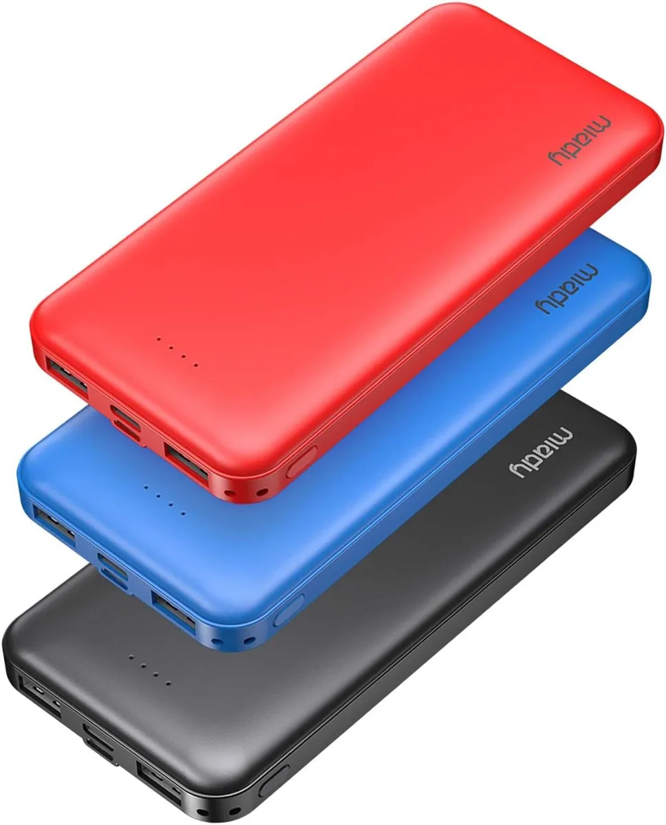 Three slim rectangular power banks in red blue and black lying side by side