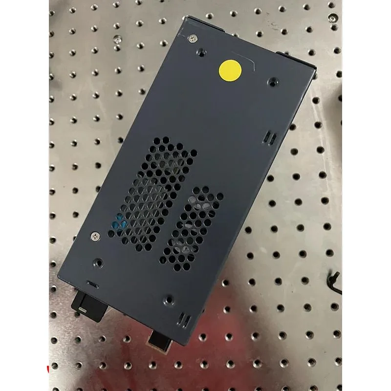 Rectangular metal ATX power supply unit with cooling fan and cable bundle