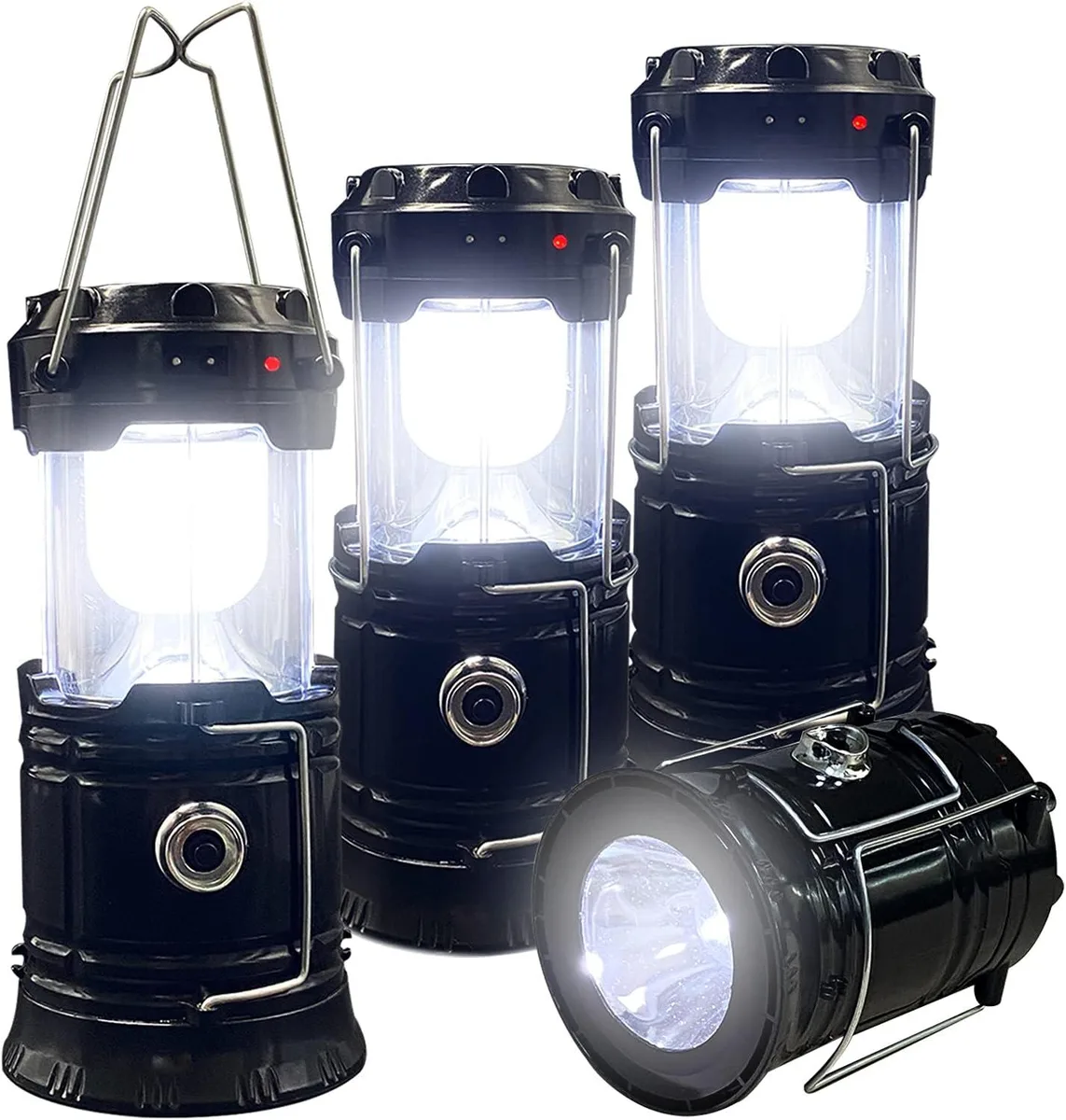 Four collapsed lanterns in a row, each a small white cylinder with a fold-out handle and solar panel on top