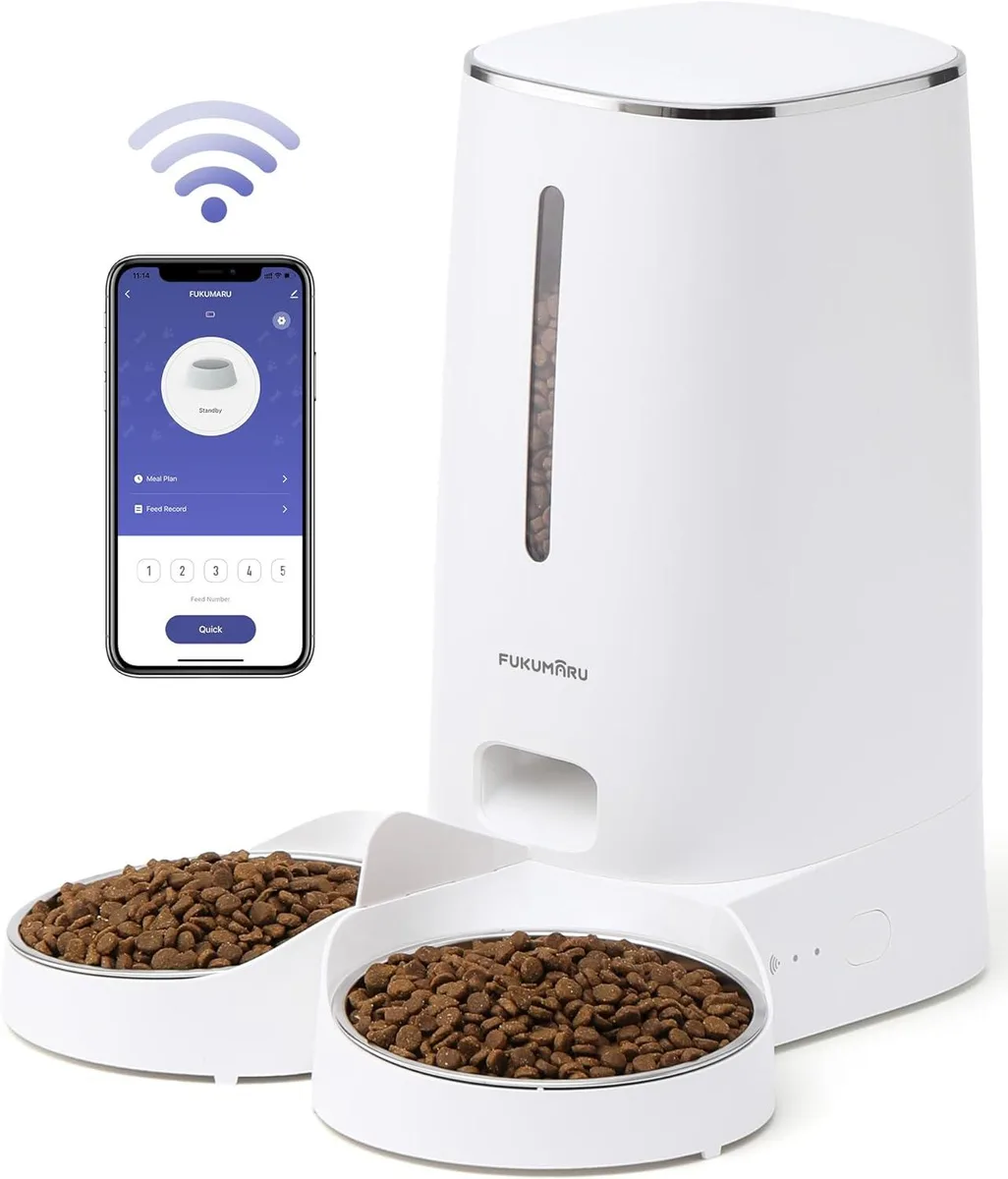 White cylindrical pet feeder with dual stainless steel bowls and control panel on top