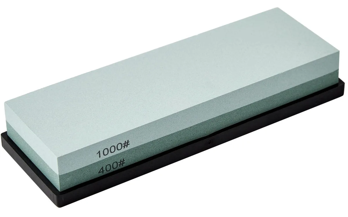 Green double-sided whetstone on black rubber base