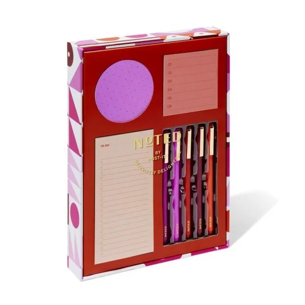 Red gift box with clear lid holding turquoise square notes, mint planner, blue habit tracker, patterned washi rolls, felt pens