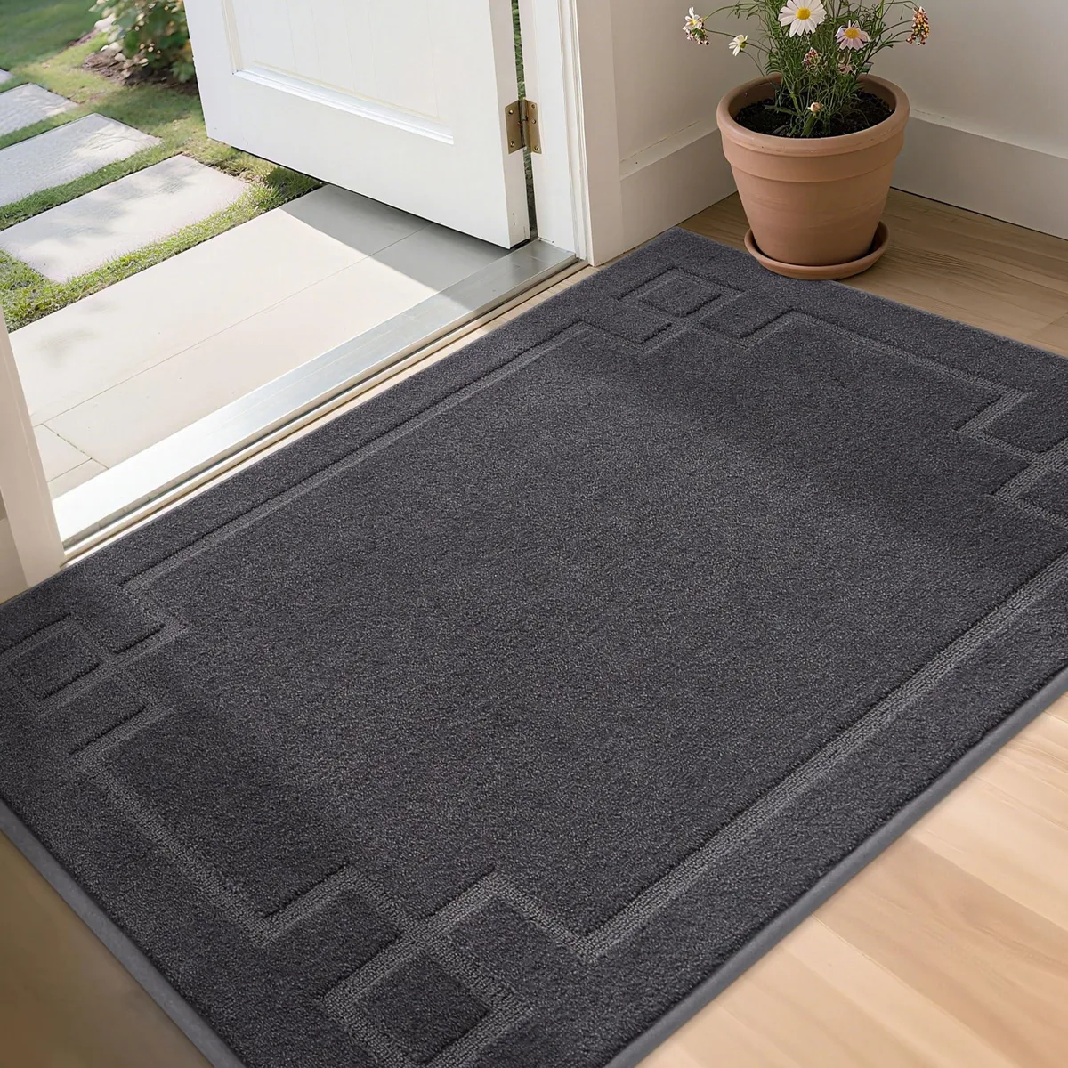 Rectangular dark grey door mat with striped pattern, low-profile flat weave, shown lying flat on floor