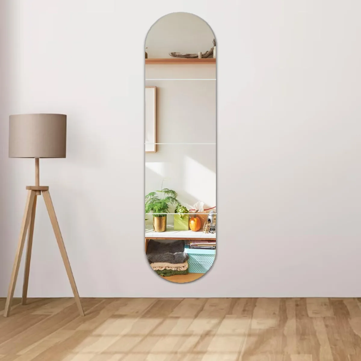 Four square acrylic mirror tiles in silver finish, each twelve by twelve inches, thin flexible sheets with adhesive backing