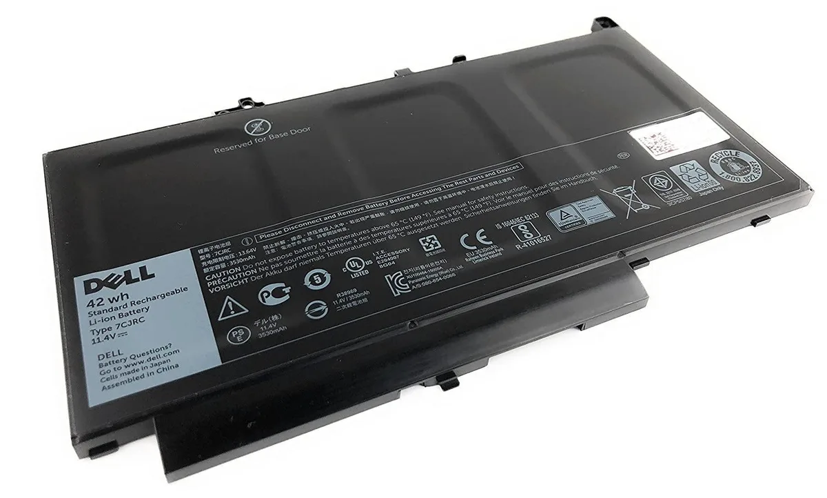 Rectangular black lithium-ion battery with silver label showing Dell part numbers