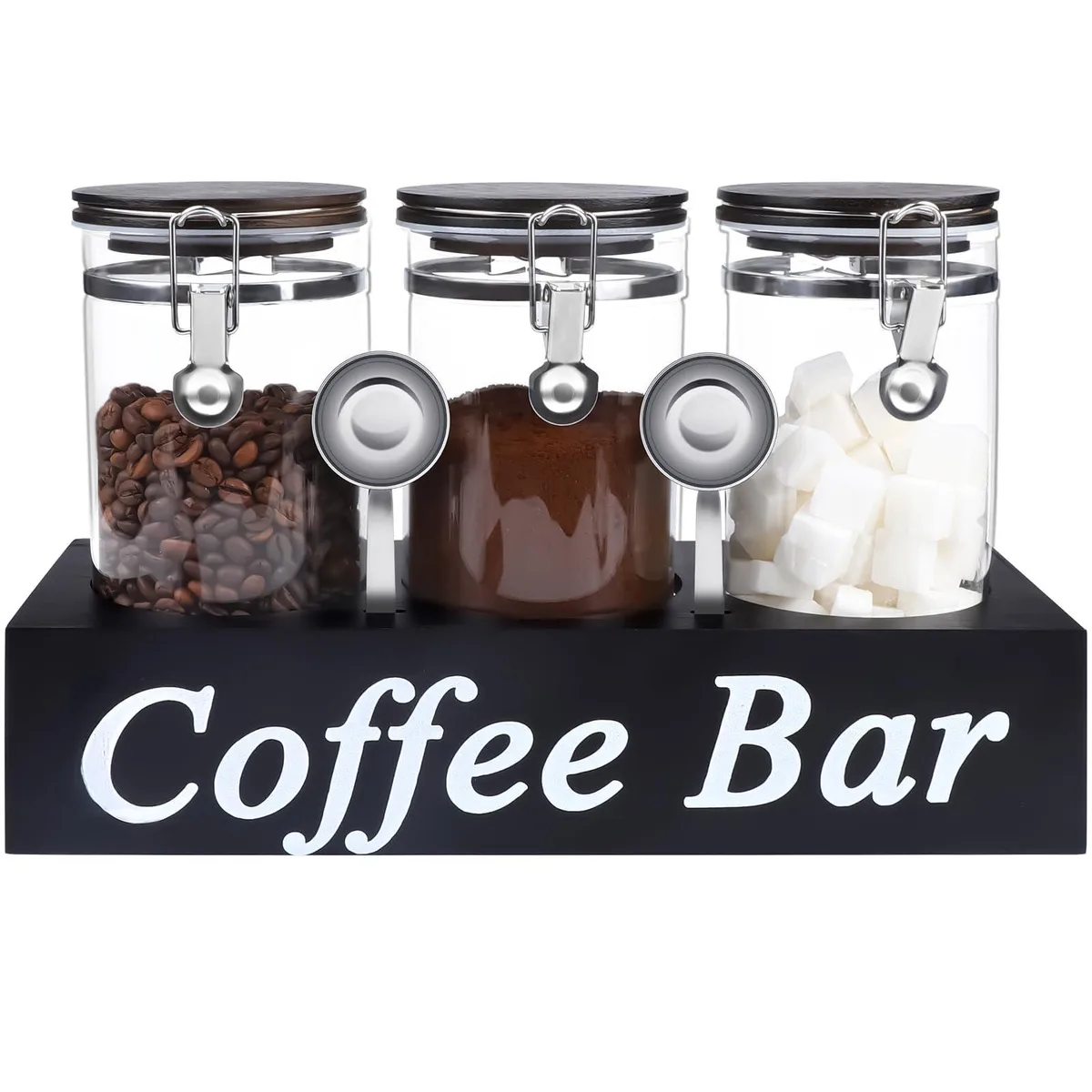 Three glass jars with black wooden lids on a wooden shelf