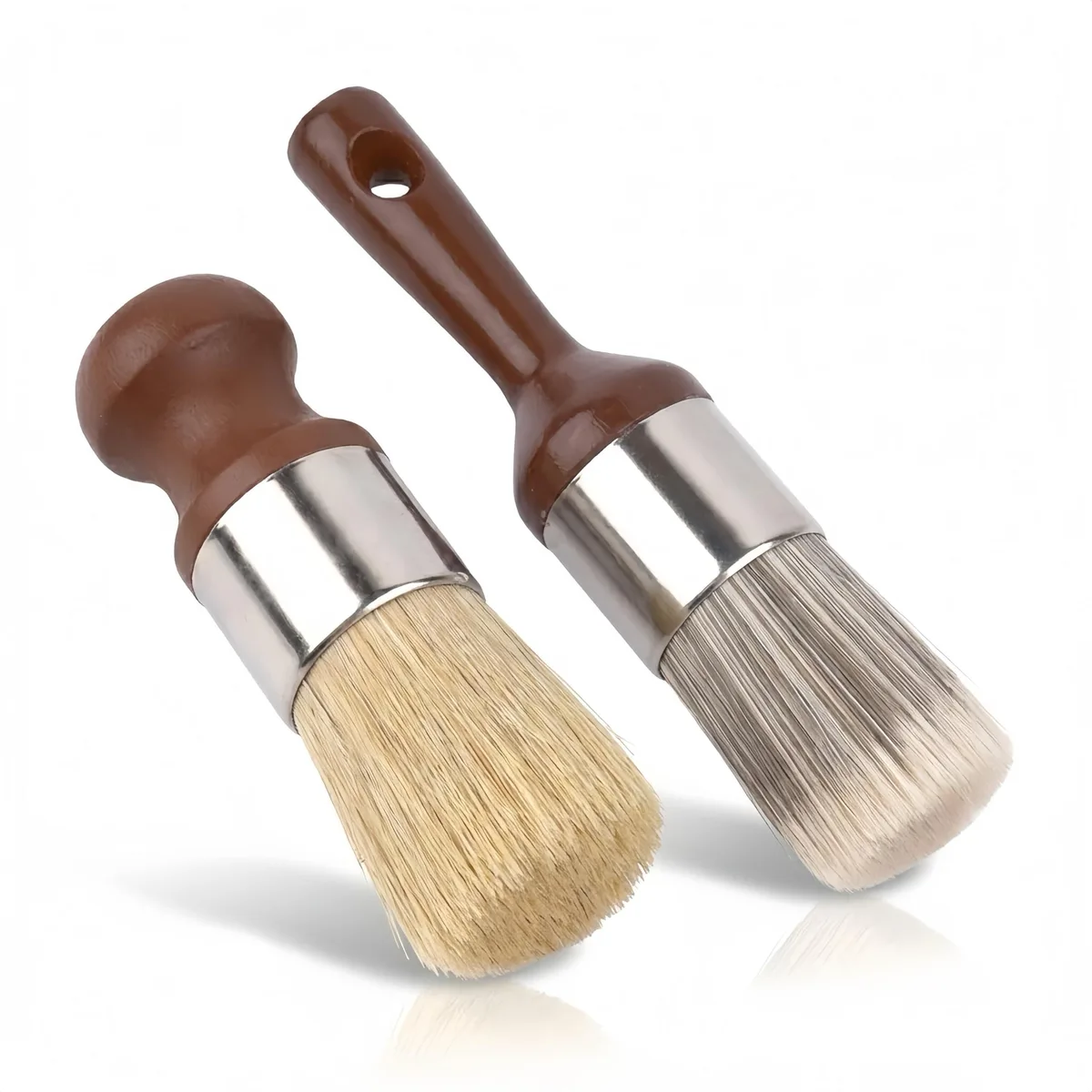 Two brown wax brushes with wooden handles and soft bristles, one long and one short