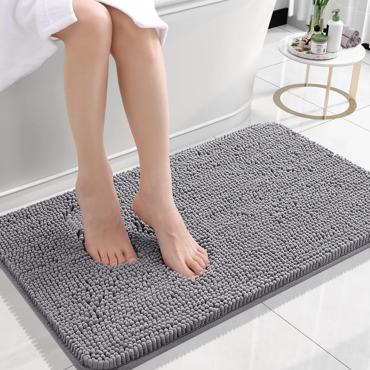A grey chenille runner rug with rubber backing, 24 by 16 inches