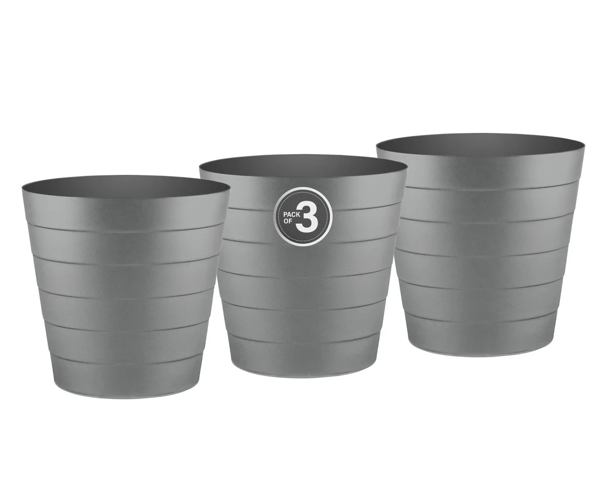 Three white 1.3 gallon round plastic wastebaskets with wave pattern