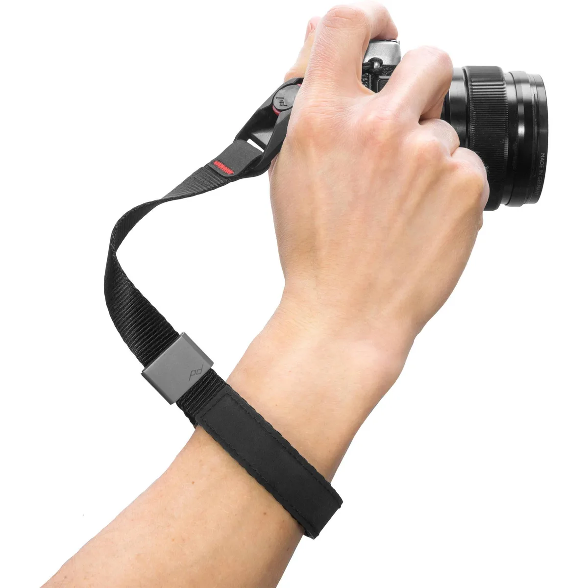 Black fabric wrist strap with silver metal connectors, worn coiled on wrist