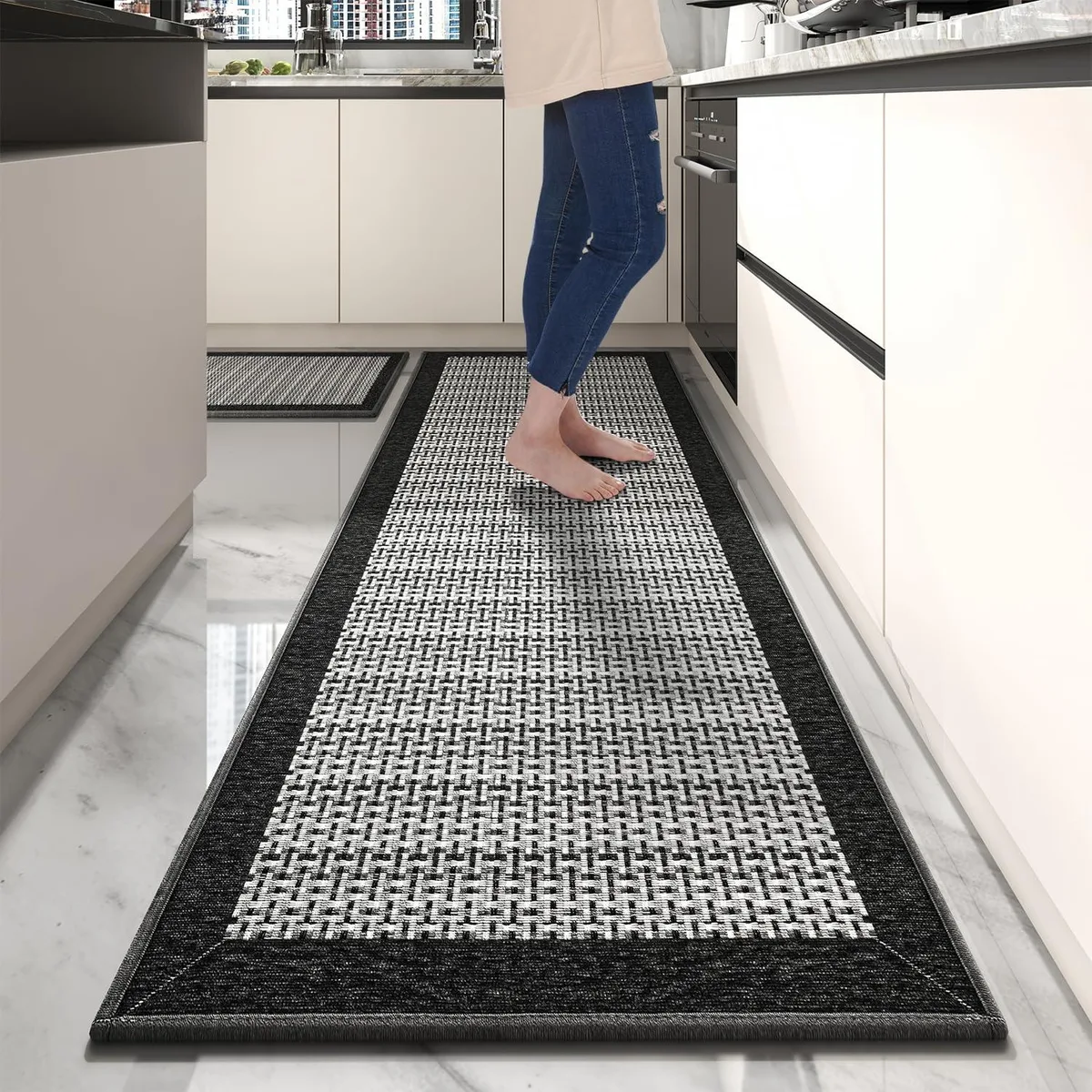 Two-piece black kitchen rug set, low-pile polyester with rubber backing, rectangular runners 72 by 30 inches and 20 by 32 inches