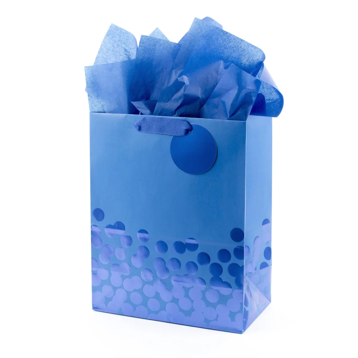 Blue paper gift bag with foil polka dots and grosgrain ribbon handles