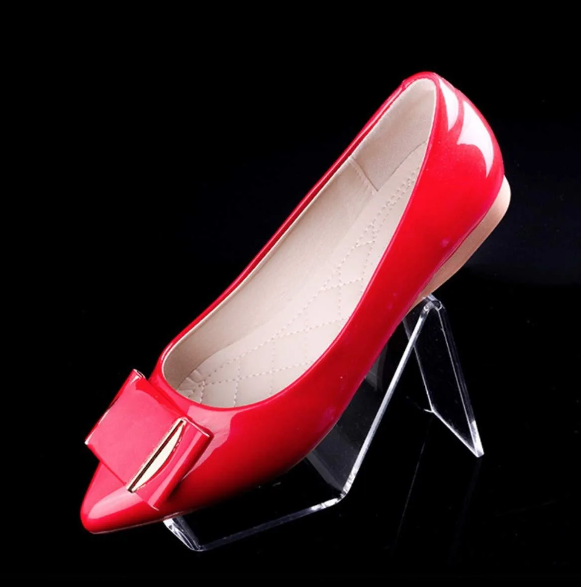 Ten clear acrylic shoe display risers with open stepped form