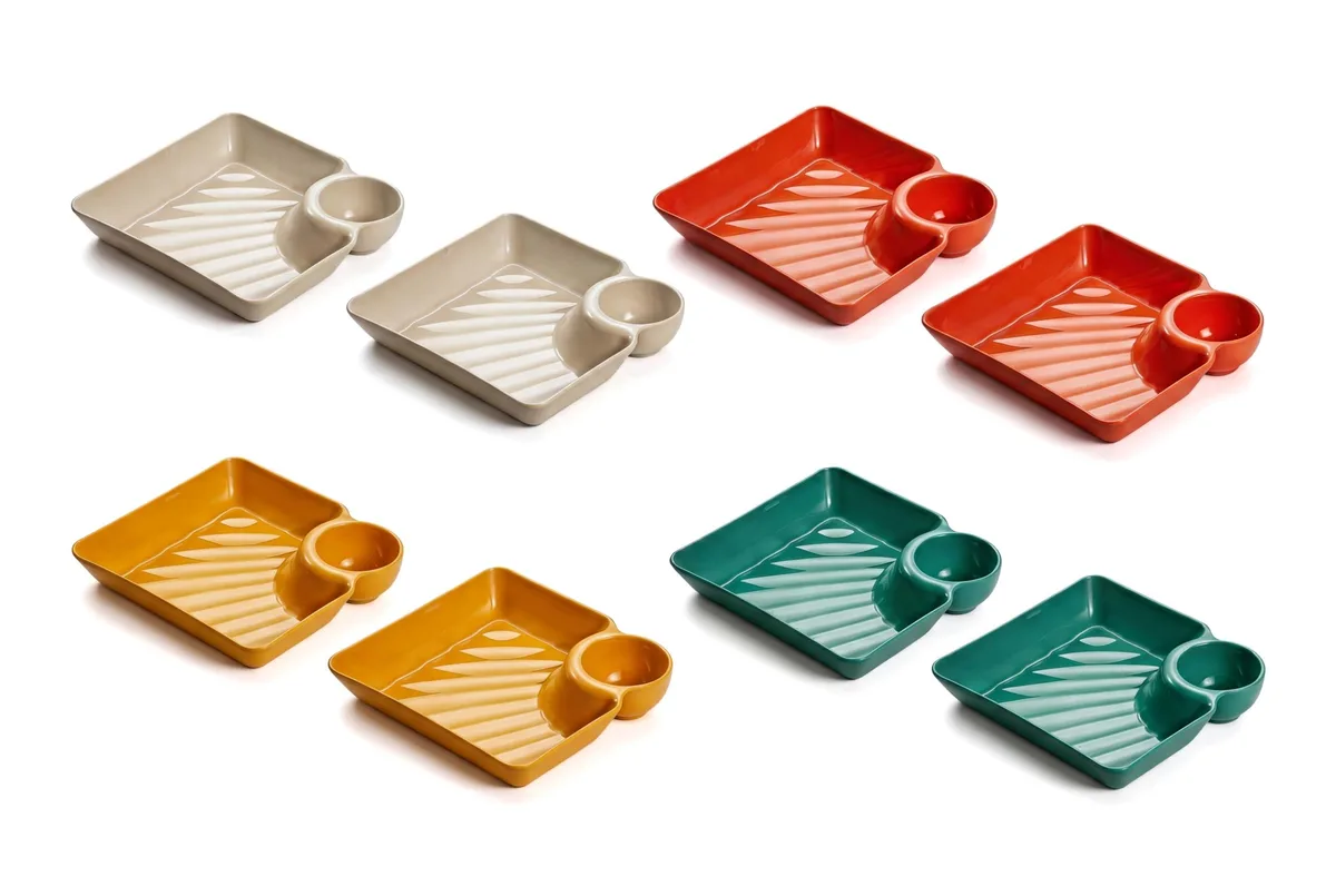 Eight plastic chip and dip plates in green, orange, red and cream, each with a built-in sauce cup, stacked together