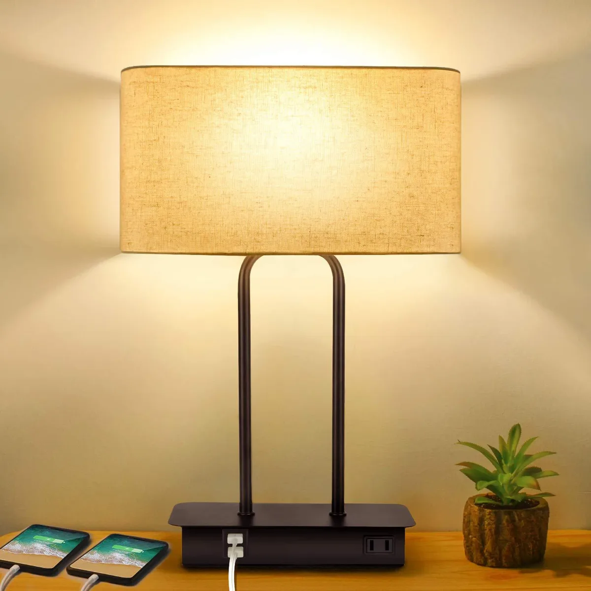 Matte black metal base with fabric shade, USB ports and AC outlet visible
