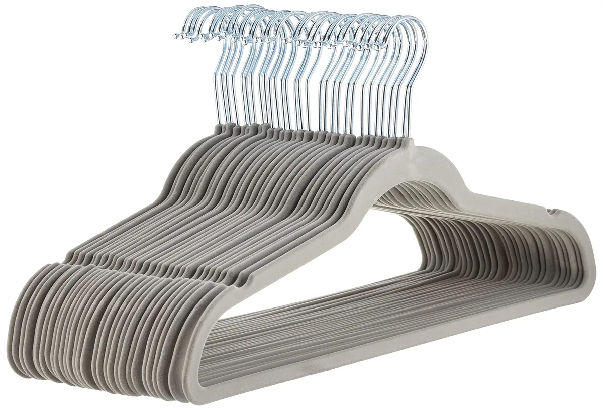 Thirty slim gray velvet hangers with silver metal hooks, stacked together