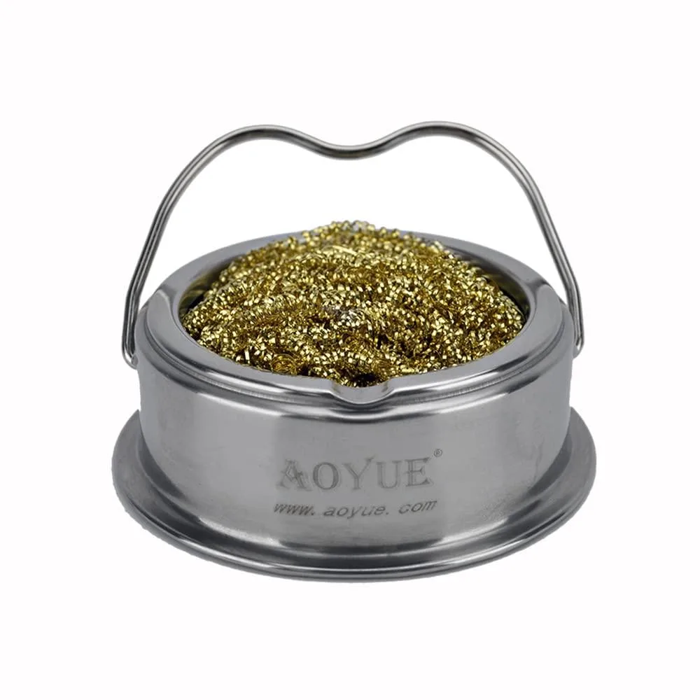Compact stainless steel pot with brass coil interior and side indents for iron rest