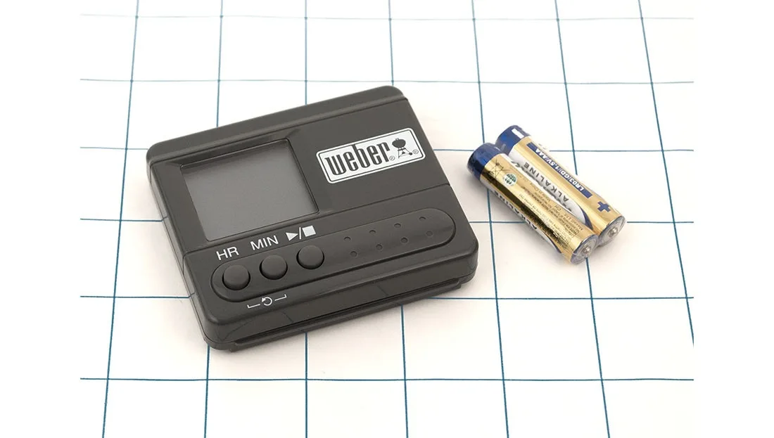 Grey rectangular digital timer with backlit display and control buttons