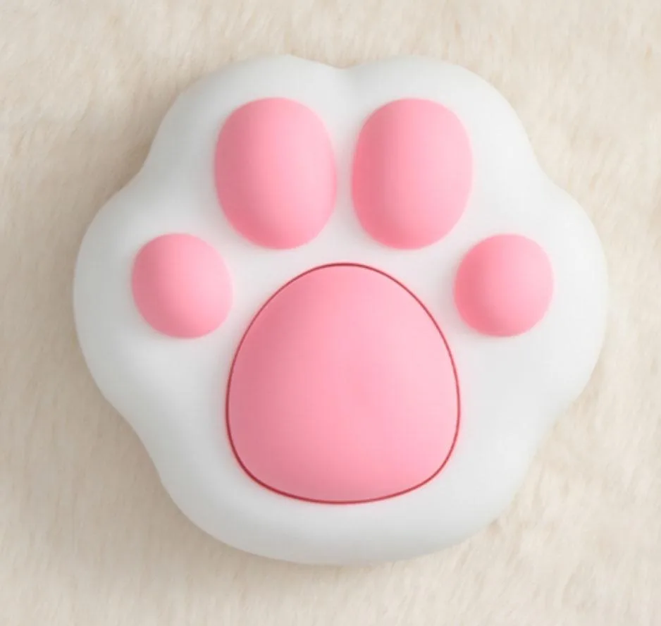 Pink cat-shaped wireless power button on white base, 10 cm tall