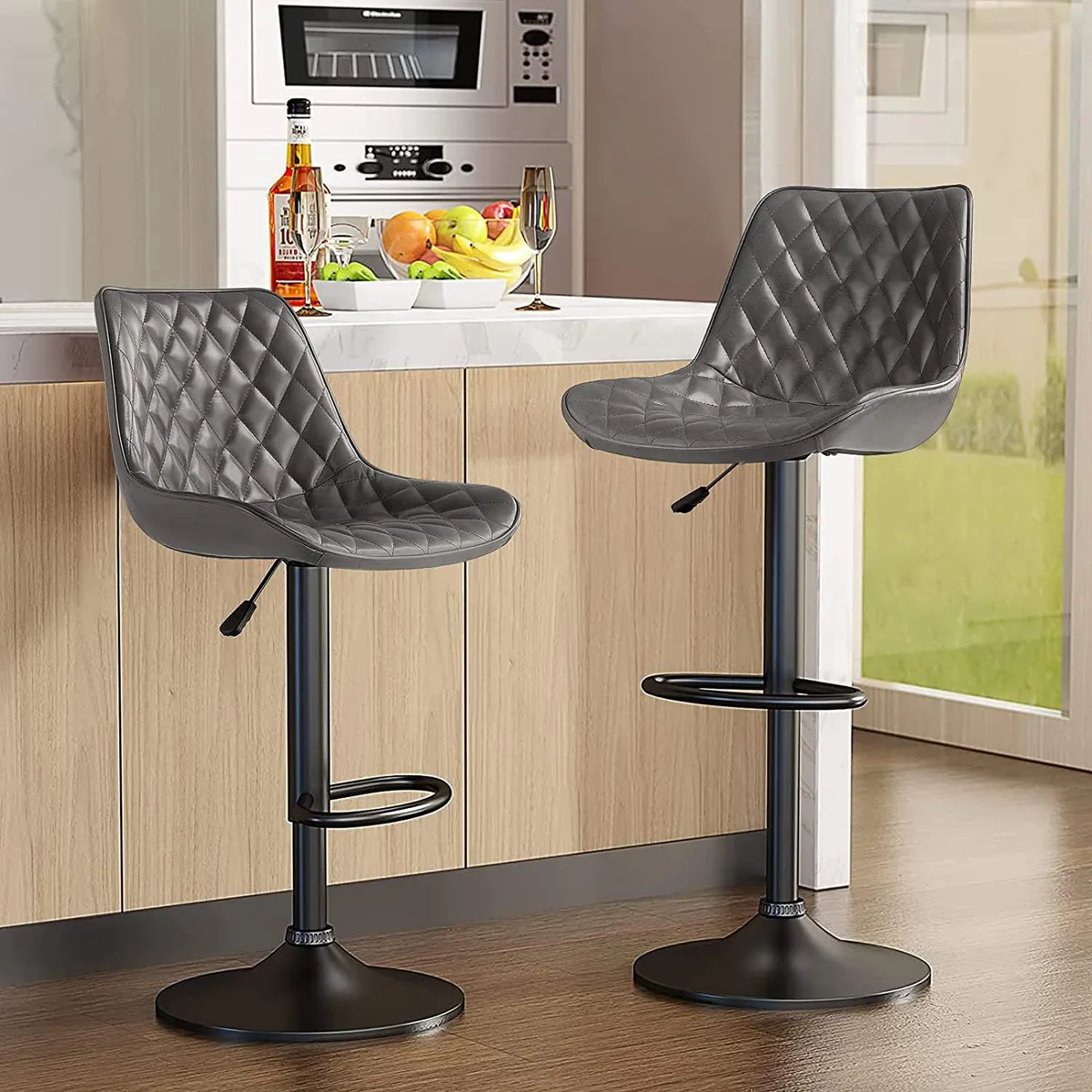 Two grey adjustable barstools with swivel seats, backrests, footrests and chrome bases