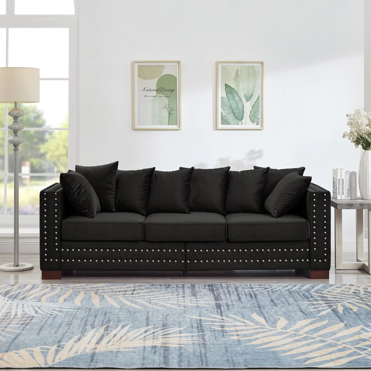 Black velvet sofa with square arms and silver nail trim