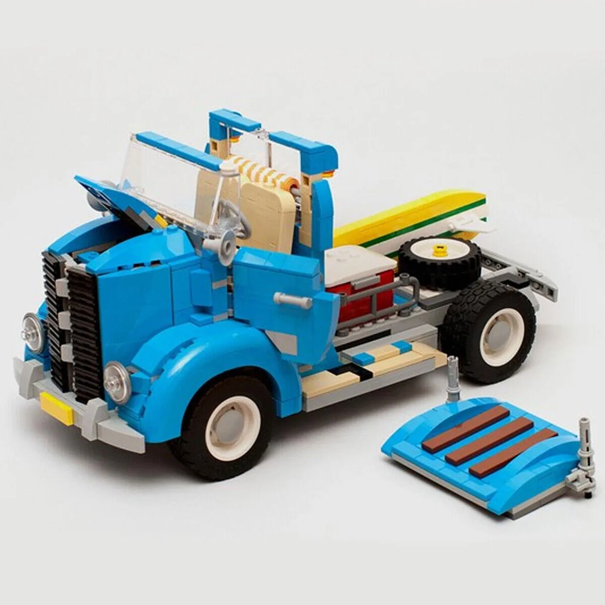 Colorful plastic building bricks in assorted shapes and wheels forming a vintage truck model