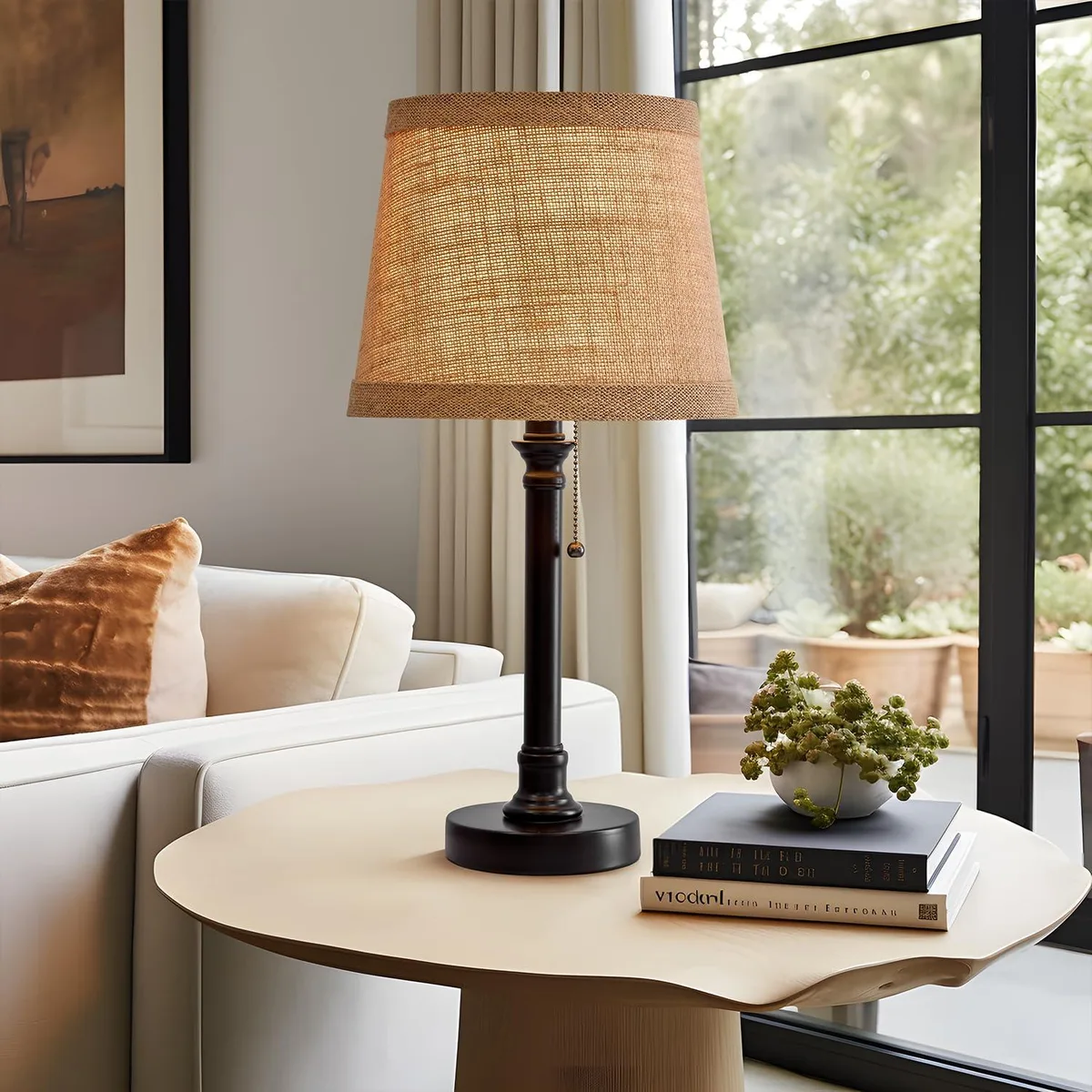 Black cylindrical base with oval linen shade, 19.5 inches tall