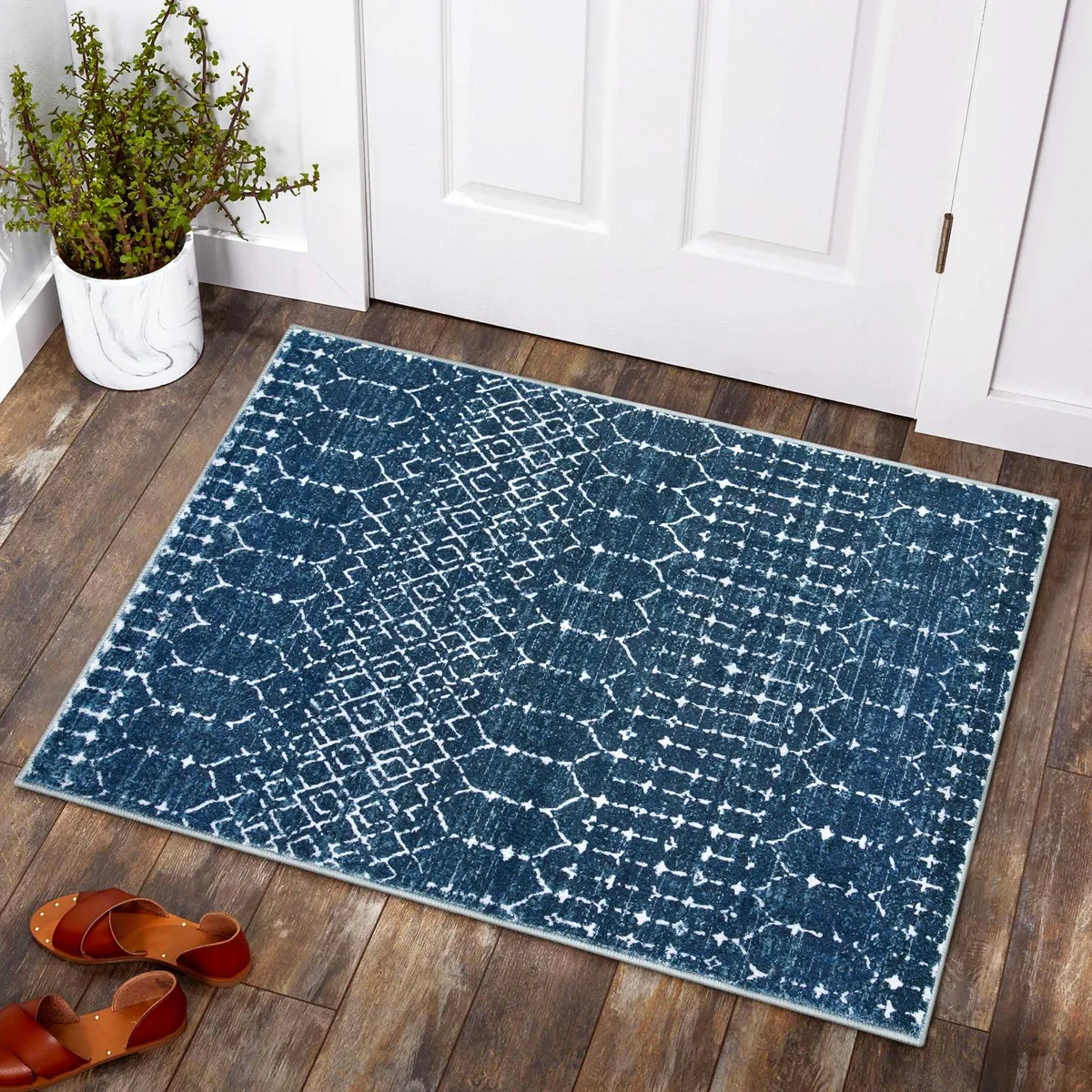 Rectangular blue rug with geometric distressed pattern, low-profile .3 in thick, non-slip backing