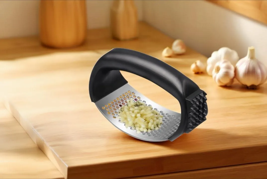 Black stainless steel garlic press with ergonomic arc-shaped silicone handle