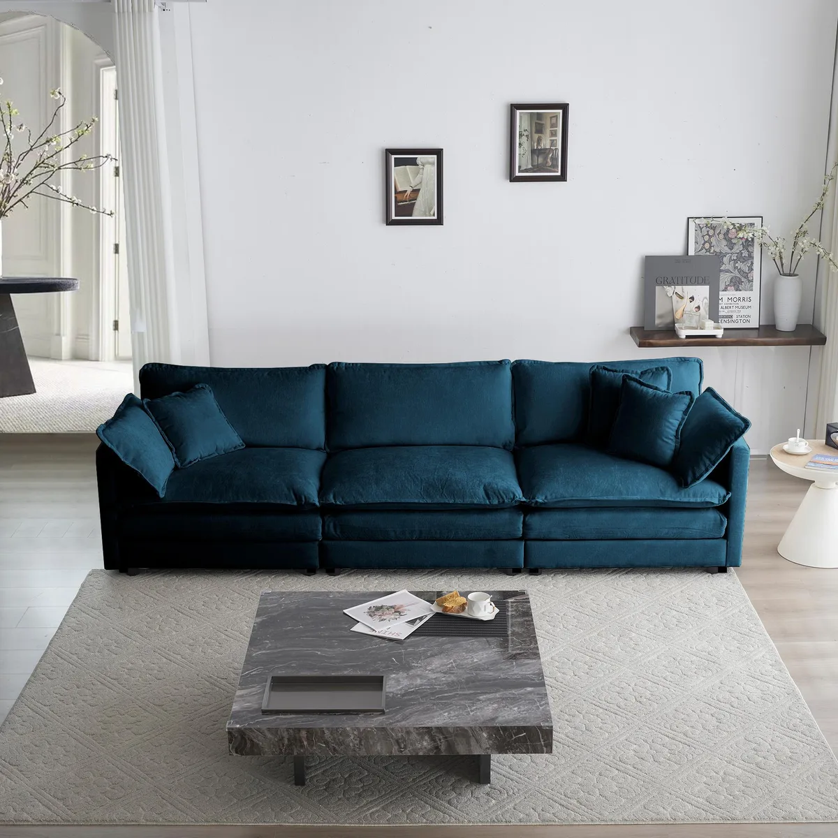Blue chenille three-seater sofa with five matching pillows