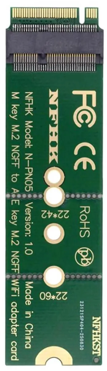Green circuit board with gold M.2 edge connectors and silver slot, NVMe to wireless adapter