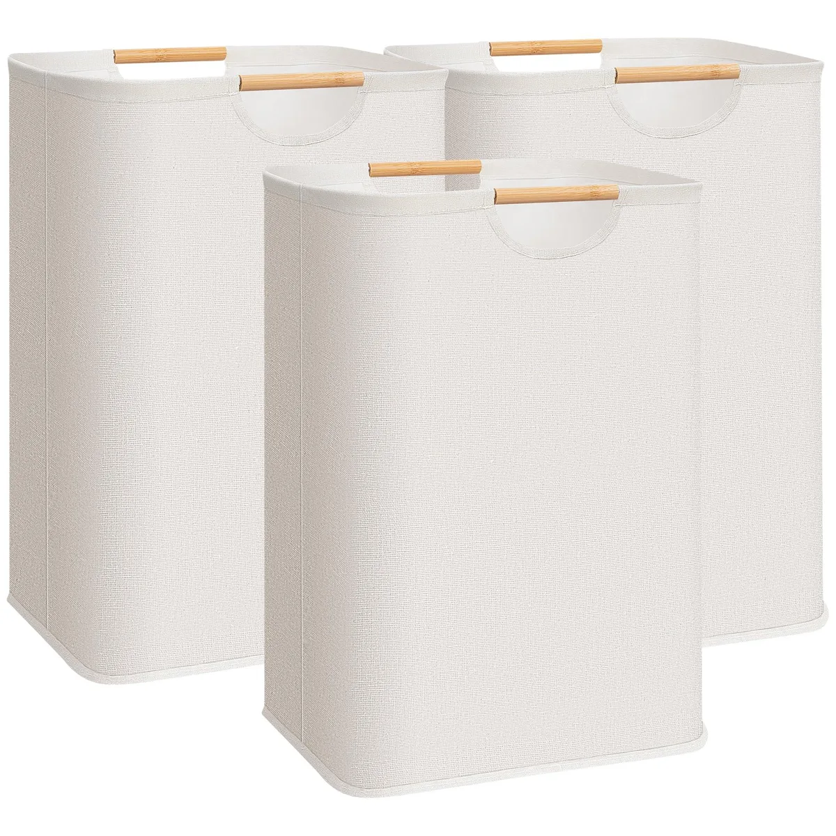 Three beige canvas laundry hampers with bamboo handles, freestanding and collapsible